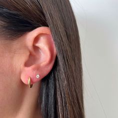 The Gold Dome Huggie Earring is a unique spin on a traditional huggie, thanks to its dome-like silhouette. Crafted from 14k gold, this huggie is perfect for everyday wear and looks just as good in the lobe as it does higher up the ear. Round Ear Free Lobe Piercings, Two Piercings Ear Ideas, 2 Piercings Ear Ideas, Ear Pricing, Double Ear Piercing, 2nd Ear Piercing, Double Piercing Earrings, Second Ear Piercing, Double Ear Piercings