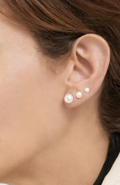 Bring classy style to your wardrobe with this set of three pearl stud earrings crafted in 14-karat gold plate. Set of 3 pairs Post back Pearl sizes: 5mm, 8mm and 10mm 14k-gold plated brass/pearl Imported Three Ear Piercings Pearl, 2 Earrings Piercings Pearl, Pearl Earrings Multiple Piercings, Pearl Stack Earrings, Pearl Earrings Studs Classy, Pearl Earring Stack, Pearl Piercing, Triple Ear Piercing, 3 Ear Piercings