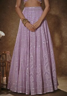 Elevate your wedding guest look with our Lilac Thread work Lehenga Set. Crafted from georgette, this set is a stunning blend of elegance and intricate detailing. The floral lehenga is adorned with exquisite thread and sequins, creating a captivating design that will turn heads. With the added convenience of pockets and cancan, this ensemble combines style and functionality. The matching short-sleeved blouse features a charming bow tie at the front, complemented by cutdana tassels at the hem. Com Thread Work Lehenga, Floral Lehenga, Work Lehenga, Georgette Dupatta, Vacuum Storage, Embroidered Lehenga, Lehenga Blouse, Wedding Guest Looks, Thread Work