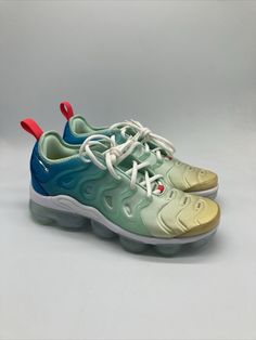 Elevate your sneaker game with these Nike Air VaporMax Plus in Mint Foam, Laser Blue, and Lime. The perfect addition to any women's athletic shoe collection, these sneakers are designed with a stylish and comfortable look in mind. Featuring the iconic Nike Air Vapormax Plus model, these shoes come in women's sizes 7.5-9.5 and are perfect for any occasion. The green colorway and sleek design make these shoes great for both casual and active wear. The brand's attention to detail and quality is evident in every aspect of the shoe, from the DQ7651-300 style code to the Nike Air VaporMax product line. Get ready to turn heads and feel amazing in these Nike Air VaporMax Plus sneakers. Green Lace-up Running Shoes With Air Cushioning, Green Slip-on Running Sneakers, Green Custom Sneakers With Boost Midsole For Sports, Green Mid-top Sports Sneakers, Green Mid-top Sneakers For Sports, Green Custom Sneakers With Translucent Outsole For Sports, Nike Custom Lace-up Sneakers For Light Sports, Green Mid-top Sneakers For Light Sports, Green Low-top Sneakers With Translucent Outsole