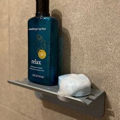 a bottle of relax on a shelf next to a soap dispenser