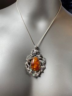 "ARTISAN AMBER PENDANT comes with 18\" chain Hand-made Sterling Silver 925. Stones used: Baltic Amber, Cubic Zirconia. Height -2 2/16\" (with bail), Width - 1 3/4\" Height - 67mm, width-40mm. Unique Handcrafted One-of a-kind Design Pendant. Each Piece of Jewelry in my Collection is One of a kind. When you start wearing a piece of my jewelry you will fall in love with it more and more each day and feel that good energy that I pass into it while creating this piece of Art. I use only natural uniqu Amber Large Pendant Necklace For Formal Occasions, Amber Necklace With Large Pendant For Formal Occasions, Formal Amber Necklace With Large Pendant, Luxury Silver Cabochon Necklace, Luxury Silver Necklace With Cabochon, Exquisite Pendant Necklaces, Amber Necklace Hallmarked For Anniversary, Amber Hallmarked Necklace For Anniversary, Elegant Amber Sterling Silver Necklace