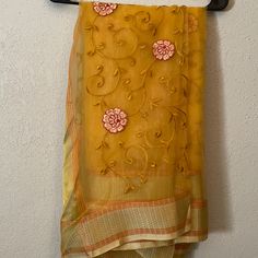 Beautiful Mustard Organza Saree. Floral Embroidery Throughout With Gold Border. Perfect For Any Occasion! Unworn And Brand New. Can Be Worn With Burgundy Or Gold Blouse For Two Completely Different Looks! Gold Silk Fabric With Dori Embroidery, Yellow Blouse Piece With Floral Embroidery For Wedding, Semi-stitched Yellow Saree With Floral Embroidery, Designer Yellow Saree With Floral Embroidery, Embroidered Silk Blouse Piece In Yellow, Yellow Embroidered Silk Blouse Piece, Festive Yellow Blouse Piece With Floral Embroidery, Festive Yellow Floral Embroidery Blouse Piece, Orange Dola Silk Dupatta With Resham Embroidery