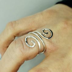 Adjustable Thumb Rings. Silver Bypass Ring For Women. Minimalist Index Finger Ring. Midi Rings. Spiral Wrap Around Rings. Gifts For Wife/Girlfriend.  This stunning spiral shaped ring will become your favorite everyday ring.  Pairs beautifully with any outfit, day or night!  Made in sterling silver wire. Each ring is entirely made by hand.   Lightly hammered to add strength by work hardening the wire. This also adds lovely texture and ensures strong durability.  Designed to be adjustable for your Bypass Rings, Index Finger Ring, Double Rings, Gold Pinky Ring, Open Heart Ring, Thumb Rings Silver, Index Finger Rings, Fine Silver Jewelry, Bypass Ring