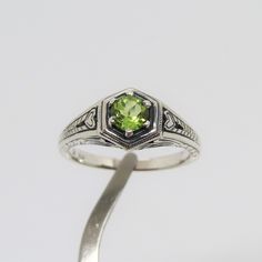 Vintage Sterling Silver Natural Peridot Filigree Ring ....Marked 925...Total of weights 2.9grams....Size 7....Measure of stone 5.1MM...It's in very good condition. Peridot Wedding Ring Silver, Silver And Green Ring, Peridot Rings Stamped 925 For Anniversary, Heirloom Sterling Silver Green Ring, Green Sterling Silver Engraved Ring For Anniversary, Classic Silver Peridot Rings, Classic Silver Ring With Peridot, Classic Peridot Birthstone Ring, Pretty Engagement Rings