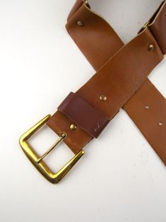 "Two vintage 1970's men's leather belts. Very good vintage condition with minor wear. Brown leather belt has brass tone buckle. Measures 31\" long x 2\" wide. notches at 24 1/2\", 25 1/2\", 26 1/2\", 27 1/2\", 28 1/2\" Black leather measures 32 1/2\" long x 1 1/2\" wide notches at 26 1/2\", 27 1/2\", 28\", 29\", 30\"" Vintage Belts And Suspenders For Everyday Use, Vintage Belts With Brass Buckle For Everyday Use, Vintage Leather Belts And Suspenders In Brown, Vintage Leather Belt And Suspenders In Vintage Brown, Brown Leather Belts And Suspenders With Brass Hardware, Vintage Leather Belt With Brass Buckle, Vintage Brown Leather Belts And Suspenders, Vintage Belts With Rectangular Antique Buckle, Vintage Leather Belts And Suspenders With Matching Belt