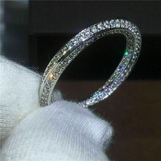 a diamond ring sitting on top of a white cloth