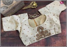 This is a cream color raw silk blouse with golden chumki work. This has a beautiful back neck with dori in the back and has a standard front opening. It fits size 40. It is a classy blouse perfect to pair with silk sarees. Size: 40 Please note: Color may vary slightly from the picture. Loose threads and pulled threads are common in embroidered clothing and it is not a defect. Cream Blouse For Saree, Unstitched Slub Silk Blouse Piece For Party, Designer Slub Silk Blouse With Dori Work, Slub Silk Blouse Piece With Dori Work, Slub Silk Saree Blouse With Dori Work, Traditional Wear With Gold Dori Work On Cotton Silk, Gold Traditional Wear With Dori Work, Cotton Silk, Elegant Slub Silk Blouse With Cutdana, Slub Silk Cutdana Blouse Piece For Parties