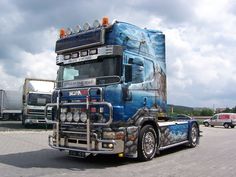 a large blue truck parked in a parking lot