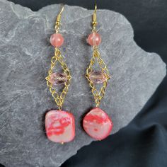 Add a playful pop of color to your accessory collection with our Pink Shell Trapeze Earrings! Made with a pink shell bead on a trapeze chain, these earrings also feature clear pink and round pink beads for a fun and unique look. Perfect for any occasion! Pink Beads, Shell Beads, Style Earrings, Gemstone Earrings, Jewelry Earrings Dangle, Etsy Earrings, Dangle Drop Earrings, Color Pop, Shells