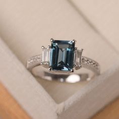 This ring features a 7*9mm emerald cut London blue topaz and sterling silver finished with rhodium. Customization is available. It is made by hand, and it will take about 7 days to finish the ring after your payment is completed. Main stone: London blue topaz Main stone weight: Approx 3.3 ct Metal type: sterling silver finished with rhodium Accent stone: cz Customization is available, I also can make it with 14k solid gold (white or yellow or rose) and diamond accent stone, just feel free to con Elegant Baguette Cut Topaz Promise Ring, Timeless Emerald-cut Sapphire Ring In Sterling Silver, Timeless Emerald Cut Sapphire Ring In Sterling Silver, Elegant Octagon Topaz Ring With Center Stone, Elegant Baguette Cut Topaz Ring With Accent Stones, Elegant Emerald Cut Topaz Ring With Center Stone, Classic Emerald-cut Topaz Ring In Sterling Silver, Wedding Topaz Ring With Baguette Cut, Emerald-cut Topaz Ring In 14k White Gold