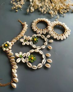 "Shop our exquisite collection of handcrafted cowrie shell jewelry, featuring a stunning necklace, earrings, and shell bangles adorned with delicate floral accents. Each piece is meticulously crafted with love and care, showcasing the beauty of nature and bohemian style. Elevate your look with these unique and eye-catching accessories, perfect for beach vibes, festivals, or everyday wear. Embrace the essence of seaside charm and make a statement with our handcrafted cowrie shell jewelry set. Sho Cowrie Shell Jewelry For Navratri, Cowry Shell Jewelry, Cowrie Shell Jewelry Diy, Choker Set Design, Cowrie Shell Jewelry Necklaces, Shell Jewelry Ideas, Shell Bangles, Flower Jewellery For Mehndi, Festive Accessories