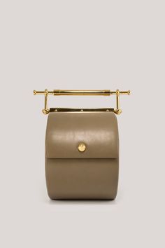 Thana Caccia – daana saakena Gold Leather Shoulder Bag With Round Handle, Luxury Gold Box Bag With Top Carry Handle, Gold Luxury Box Bag With Top Carry Handle, Luxury Gold Box Bag With Top Handle, Gold Luxury Box Bag With Top Handle, High-end Gold Box Bag With Top Carry Handle, Gold Shoulder Bag With Top Handle And Brass Hardware, Gold Top Handle Shoulder Bag With Brass Hardware, Luxury Bucket Bag With Brass Hardware