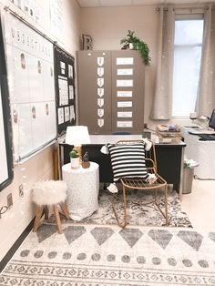 an office with a chair, desk and computer on the wall in front of it