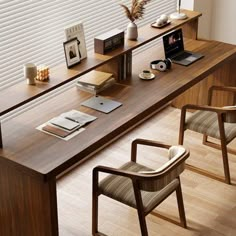 a desk with two chairs and a laptop on it