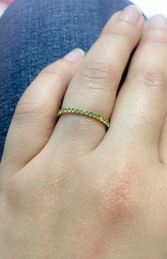 "Full Eternity Band Ring with U Micro Pave Set Natural Genuine Peridot. Material: Solid Gold (14K or 18) Finish: High Polished /Shiny Fit: Comfort Fit (Rounded Interior) Width: 1.8 mm Height: 1.8 mm Setting Type: U Micro Pave (Reminds the letter\"U\") Stone: Natural Green Peridot Cut & Shape: Round, Diamond Cut Total Carat Size: apx 0.70+ ct Quantity of Stones: apx 38 (Varies by ring size) Quality: AAA Peridot has a unique shade of lime green that looks different green depending on inside/ou Green Diamond Eternity Band With Prong Setting, Green Diamond Round Eternity Band, Green Half Eternity Fine Jewelry Band, Green Round Eternity Band Fine Jewelry, Fine Jewelry Green Round Eternity Band, Green Round Eternity Band In Fine Jewelry, Green Eternity Band With Prong Setting As Gift, Green Stackable Eternity Band For Promise, Green Stackable Rings With Prong Setting