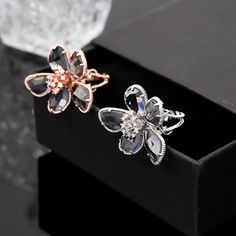 Our Crystal Flower Ring is a unique and stylish statement piece, perfect for collectors who appreciate craftsmanship and natural crystals Handmade with love, this ring offers multiple choices to suit any taste and occasion. It's an ideal personalized gift that can enhance your wardrobe and personality with the healing power of crystal. Crafted with an alloy and electroplated with rose gold, this exquisite ring features a stunning floral design with artificial gems/semi-precious stones. Individua Rose Gold Flower Ring For Gift, Rose Gold Crystal Jewelry With Flower Shape, Rose Gold Flower Rings For Party, Rose Gold Crystal Flower-shaped Jewelry, Rose Gold Crystal Flower Jewelry, Rose Gold Flower Shaped Crystal Wedding Ring, Rose Gold Open Ring Jewelry For Party, Elegant Rose Gold Flower Ring For Party, Crystal Open Ring As Gift