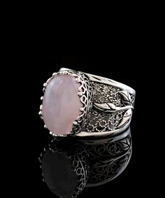 Gorgeous and unique, this filigree art rose quartz gemstone tulip detailed 925 sterling silver women's statement ring will be the center of attention! Handmade for a one-of-a-kind look, it's sure to spark conversation and admiration from all who see it. Why not treat yourself to standout style? The oval-cut cabochon rose pink quartz stone is 10x14 mm and is bezel set. The ring face measures 0.60" x 0.45" and the band width is 1.20 mm. The statement ring is oxidized and highly polished for catchi Elegant Floral Rings With Rose Details, Elegant Rose Gold Flower Ring With Roses, Elegant Rose Gold Flower Ring With Gemstone, Elegant Rose Detail Rings For Anniversary, Elegant Rose Flower Ring As Gift, Elegant Rose Flower Ring For Gift, Elegant Rose Colored Flower Ring As Gift, Elegant Rose-colored Flower Ring For Gift, Elegant Rose-colored Flower Ring As Gift