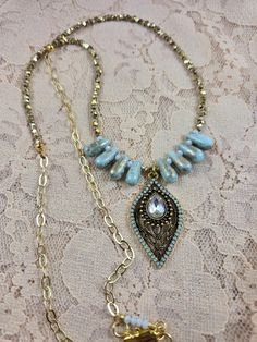 This elegant statement necklace makes a nice gift for a birthday, anniversary, the holidays or for any special occasion or for a night out on the town! It can be worn all year round. It is designed with pale turquoise and gold glass teardrop beads, gold shiny metal beads, a gold chain and lobster claw clasp, and a color coordinated pale turquoise, crystal and gold plated teardrop pendant. The drop length is 14 inches.  If you look through my earring and bracelet collection you should be able to find pieces designed with the same beads to create a matching jewelry set if they are still available. Gold Teardrop Jewelry With Beaded Chain, Gold Teardrop Pendant Jewelry For Party, Bohemian Teardrop Necklace For Party, Dangle Drop Necklace With Beaded Chain For Party, Beaded Chain Drop Necklace For Party, Gold Crystal Necklaces With Faceted Beads For Party, Gold Turquoise Necklace With Beaded Chain As Gift, Gold Jewelry With Faceted Beads For Festival, Gold Jeweled Festival Jewelry