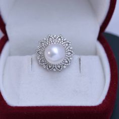 Get dressed up with our 10-11mm Freshwater Pearl & Round Cubic Zirconia. It has the perfect combination of elegance and style. The freshwater pearl creates a timeless look that makes this piece an ideal choice for any outfit. The round cut Cubic Zirconia add just the right amount of sparkle and shine to the overall design. This ring is perfect for special occasions or everyday wear, so you can show off your glamourous side no matter where you go. This popular earrings design features AAAA qualit Luxury Pearl White Classic Diamond Ring, Luxury Pearl White Ring With Diamond Accents, Luxury White Pearl Drop Ring, Luxury White Gold Pearl Ring Fine Jewelry, Luxury High Luster Pearl Ring For Wedding, Luxury Pearl Ring With Halo For Formal Occasions, Luxury Engagement Pearl Ring With Pave Setting, Luxury High Luster Pearl Ring For Engagement, Luxury Pearl Ring With Center Stone For Anniversary