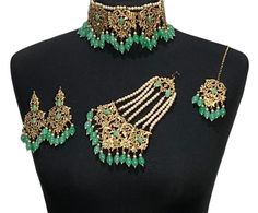 Handcrafted mint green / sea green golden diamonte Indian wedding / bridal choker jewellery set. Set includes- Earrings  Choker necklace Tikka  Jhumar Our choker is adjustable with a dori at the back giving you a comfortable fit. It comes with elegant earrings with gem detail, tikka and jhumar with hooks.  The glimmer of the diamonte gems with elegant diamonte detail make this jewelry set a truly head turning piece, a must have for every jewellery box.  Our ethnic jewellery set harmoniously blen Green Necklace With Intricate Design For Wedding, Heavy Green Necklace For Eid, Heavy Green Jewelry For Eid, Wedding Choker Jewelry With Stone Work, Traditional Jeweled Wedding Choker, Green Kundan Bridal Necklace Hand Set, Green Tilla Jewelry Sets For Reception, Green Stone Work Necklaces For Weddings, Green Stone Work Necklace For Wedding