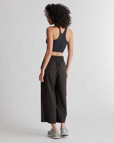 These look like classic work pants, but move like your favorite activewear. Our cropped Performance Tech Wide Leg Commuter Pants have just the right amount of stretch for days when you’re on the go, plus the sun protection and quick-dry properties of top-notch performance wear. And they look great with sneakers.  | Quince | Women's Performance Tech Wide Leg Pants in Black, Size Large, Recycled Polyester Athleisure Elastane Trousers, Sportswear Bottoms With Side Pockets And 4-way Stretch, Wide Leg Activewear With Pockets And 4-way Stretch, Stretch Wide-leg Athleisure Joggers, Functional Activewear With 4-way Stretch, Sporty Ankle-length Elastane Pants, Black Wide-leg Sports Pants, Sporty 4-way Stretch Sweatpants With Side Pockets, Versatile Compressive Bottoms For Sports