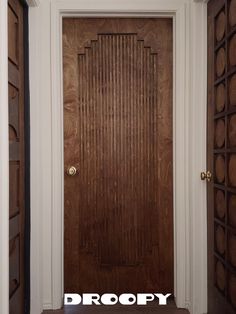 a wooden door with the word dropop on it in front of an entry way