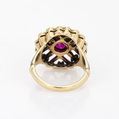 This is part of Chairish’s Fine Jewelry assortment.  Elegant and finely detailed Edwardian era enamel ring (circa 1900s to 1910s), crafted in 14 karat yellow gold.    Created ruby measures 5mm (in very good condition and free of cracks or crisps). Small natural 1mm seed pearls surround the ruby.   A created ruby is set into a beautifully detailed scrolled mount. Blue and black enamel adds a pop of colour, offering contrast to the ruby that is striking and unique. The ring is small in size (2 1/2 Vintage Gold Enamel Ring Stamped 14k, Heirloom Yellow Gold Ruby Signet Ring, Heirloom Ruby Signet Ring In Yellow Gold, Gold Ruby Ring With Bezel Setting, Heirloom Style, Heirloom Gold Ruby Ring With Bezel Setting, Antique Yellow Gold Ruby Ring, Antique Ruby Ring In Yellow Gold, Victorian Yellow Gold Rings With Ruby, Victorian Oval Enamel Ring For Anniversary