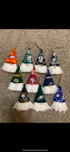 the nfl christmas ornaments are lined up on the floor