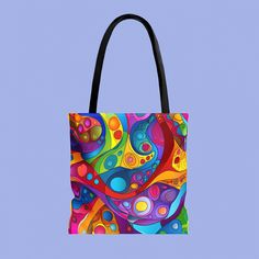 a colorful tote bag with an abstract design on the front and bottom, against a blue background