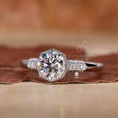 a diamond ring on top of a piece of wood