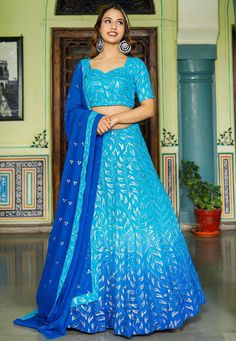 Readymade Faux Georgette Lehenga in Shaded Blue. This attire with Shantoon and Cotton Lining is Enhanced with Fancy Tassels, Resham and Sequins WorkAvailable with a Faux Georgette Blue Choli Crafted in Sweetheart Neck and Half Sleeves and a Faux Georgette Dupatta in Royal Blue. The Choli and Lehenga Lengths are 14 and 42 inches respectively. Do Note: Accessories shown in the image are for presentation purposes only. (Slight variation in actual color vs. image is possible). We sell all kinds of L Blue Georgette Sharara For Reception, Blue Sharara For Navratri Reception, Festive Semi-stitched Blue Sharara, Festive Blue Semi-stitched Sharara, Blue Sets With Dupatta In Traditional Drape, Blue Sets With Dupatta And Traditional Drape, Blue Saree Sets With Sequins, Blue Sequined Sets For Festive Occasions, Blue Sharara With Pallu For Navratri