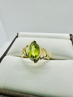 This unique and beautiful 10 karat Yellow Gold Marquise Peridot Stone measures 10 mm in length and 5 mm in width. Total weight of the ring is 2.04 grams.  Ring is a size 7 and stamped "10K" and "W". All items arrive wrapped carefully for shipping and in a gift box. Green Peridot Birthstone Ring For Formal Occasions, Green Peridot Birthstone Ring For Formal Events, Green Marquise Birthstone Jewelry, Fine Jewelry In Green Peridot, Green Peridot Fine Jewelry, Fine Green Peridot Jewelry, Green Marquise Cut Birthstone Jewelry, Fine Jewelry Green Marquise Cut, Green Marquise Jewelry With Accent Stones