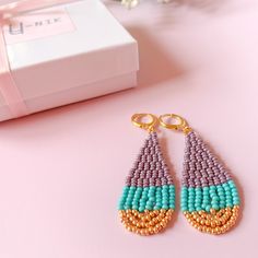 Beautiful handmade Turquoise mauve & gold teardrop earrings. These multicolor seed beaded earrings are made with high-quality seed beads and gold-plated lever backs, so if you like them, click Add to cart, and we will prepare them for you. Item description: Measures:  Length: 2 1/4 Width: 3/4 inch Materials:  -Czech seed beads -Gold Plated lever backs Shipping: These earrings will be ship the same day or the next business day. Package includes: -One pair of earrings -Paper Wrapping -Hand letter Dangle Teardrop Earrings With Tiny Beads As Gift, Gift Teardrop Dangle Earrings With Tiny Beads, Tiny Beads Drop Earrings For Gifts, Unique Teardrop Jewelry With Colorful Beads, Unique Teardrop-shaped Jewelry With Colorful Beads, Gift Teardrop Earrings With Colorful Beads, Colorful Beads Long Drop Jewelry As Gift, Multicolor Drop Earrings With Spacer Beads, Colorful Beads Long Drop Jewelry For Gift