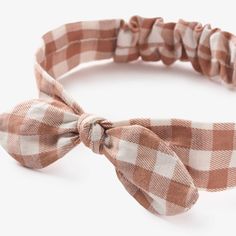 There is just something about a baby girl headband that just makes you say 'awww.' Whether it's a hair bow or headband, the right hair accessory really makes an outfit stand out. Pair this beautiful gingham headband with any of the gingham apparel pieces, whisper white horseshoe cable cardigan, or rust corduroy skirt just to name a few Soft cotton/spandex woven knotted bow, elasticized Fits babies 0-12 months Wipe clean as needed Cute Spring Headband, Playful Bow Headband Hair Accessory, Playful Summer Headband Hair Accessories, Playful Bow Hair Accessories For Summer, Playful Adjustable Bow Headband, Playful Bow Headband For Gift, Cute Cotton Hair Accessories For Summer, Cute Cotton Summer Hair Accessories, Playful Summer Hair Accessories With Bow