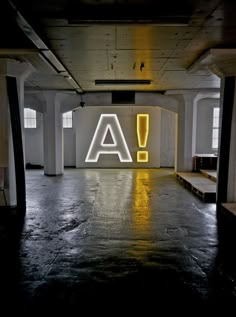 an empty room with neon letters on the wall