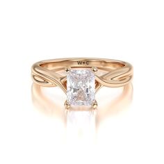 an engagement ring with a princess cut diamond in the center and twisted band around it