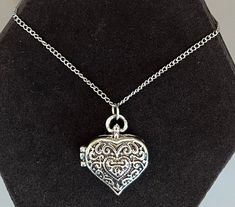 "Featuring this pretty silver tone Bali-style heart locket pendant necklace.  The Locket has a magnetic closure and measures 1-1/16\" x 15/16\".  It hangs on an adjustable chain measuring from 26\"-29\".  The necklace is in very good vintage condition." Heart-shaped Antique Silver Locket Necklace, Silver Double Heart Locket Necklace With Heart Charm, Silver Heart Shaped Locket Necklace, Nickel-free Heart Locket Necklace, Silver Metal Heart Necklace Engraved, Silver Adjustable Heart Necklace For Valentine's Day, Silver Heart Charm Locket Necklace Medallion, Silver Heart Charm Medallion Locket Necklace, Silver Nickel-free Locket Necklace For Valentine's Day