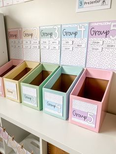 several boxes are lined up on the shelf in front of each other and labeled with groups