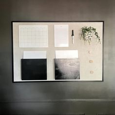 a desk with some papers and plants on it