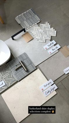 various tiles and flooring materials are laid out on the floor in different shapes and sizes