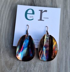 These unique hand made earrings feature copper blanks that have been shaped for design and then fire painted using a propane torch to bring out the different colors in the metal. NOTE:  Certain types of lighting will bring out the colors more than other types of lighting. These earrings measure just over2" inlength. They will ship in a gift box via USPS with tracking info provided. Artsy Nickel-free Copper Earrings, Nickel-free Copper Artsy Jewelry, Artsy Nickel-free Copper Jewelry, Artsy Brown Copper Jewelry, Artsy Copper Drop Earrings, Artistic Copper Earrings With Patina, Rust-colored Soldered Copper Earrings, Nickel-free Multicolor Copper Earrings, Multicolor Nickel-free Copper Earrings