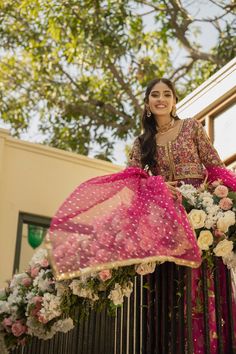 Hot Pink Lehenga and Open Frock Pakistani Bridal Dress is a breathtaking traditional masterpiece to have a dreamy royal appearance. Lavish designs and hand-crafted embellishments of gota and zardosi make this stunning Mehndi Dress your foremost priority for the big day. Pishwas: Pishwas Frock in an alluring purple sade is emblazoned with classic gota details. Threads and Sequin embellishments enhance the glamour of this beautiful Pakistani Bridal Pishwas in a front open style. Floral details, mu Festival Reception Anarkali Set With Sheer Dupatta, Festival Anarkali Set With Sheer Dupatta For Reception, Chanderi Dress With Gota Work For Reception, Dola Silk Anarkali Set With Dupatta For Reception, Anarkali Set With Dabka Work For Reception, Festival Anarkali Set With Dabka Work For Reception, Dabka Work Anarkali Set For Reception, Chanderi Gown With Gota Work For Reception, Gota Work Chanderi Gown For Reception