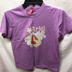 Disney Purple Tshirt T Shirt Sz Large L Ariel Little Mermaid Preowned Never Worn Condition Purple Character Print Short Sleeve Top, Purple Short Sleeve Top With Character Print, Disney Character Print Cotton T-shirt, Disney Character Print Short Sleeve Shirt, Disney Short Sleeve Shirt With Character Print, Disney Cotton T-shirt With Cartoon Print, Disney Short Sleeve Pre-shrunk T-shirt, Disney Pre-shrunk Short Sleeve T-shirt, Disney Short Sleeve T-shirt With Letter Print