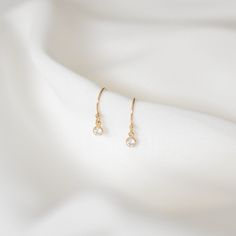 Simple and perfect for everyday wear, these dainty earrings feature a 3mm brilliant dangling cubic zirconia charm. These are all made of 14K gold filled materials and are tarnish-resistant, water-resistant, and hypoallergenic.  Comes with box and jewelry pouch, ready for gifting. --------------------♥ PROMOS ♥-------------------- Want 10% off? Join the mailing list by visiting http://bit.ly/vedern . Just leave me a note at checkout if you have any problems applying discount codes. --------------------♥ BUY WITH CONFIDENCE ♥-------------------- Don't love it? Message me to set up a return or exchange. If you find any problems with your items, just send a message with a photo, and a new one will be on its way to you! --------------------------♥ PACKAGING ♥--------------------------- Gold fil Minimalist Gold Plated Diamond Drop Earrings, Dainty 14k Gold Filled Earrings For Gift, Simple 14k Gold Filled Earrings For Gift, 14k Gold Filled Dainty Earrings For Anniversary, Dainty 14k Gold Filled Earrings For Anniversary, Dainty 14k Gold Earrings With Ear Wire, Dainty Gold Diamond Earrings With Ear Wire, Dainty Tarnish-resistant Diamond Dangle Earrings, Tiny Delicate Gold-plated Earrings