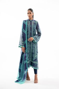 A printed navy blue cotton net shirt is adorned with elegant lacework in a turquoise hue and scalloped edging. Featuring worked buttons on the neckline, the shirt is paired with a matching printed dupatta and rawsilk trousers. Sania Maskatiya, Net Shirt, Printed Organza, Printed Dupatta, Organza Dupatta, Silk Dupatta, How To Dye Fabric, Raw Silk, Silk Shirt