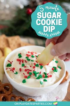 a bowl filled with white frosting and sprinkles next to pretzels