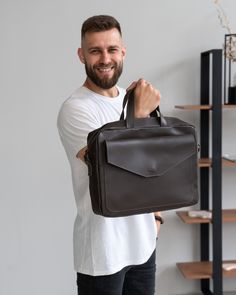 a man holding a brown briefcase in his hand