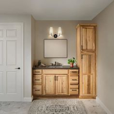 a bathroom with wooden cabinets and a rug on the floor