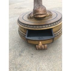 an old fashioned fire hydrant is sitting on the ground with it's lid open